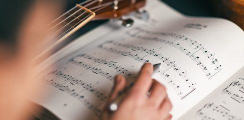 Close-up photograph of a person who studies musical score